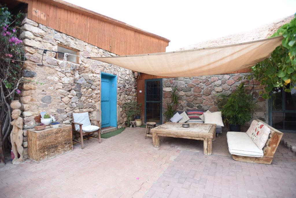 a patio with a couch and a table and a building at Williams House in Eilat