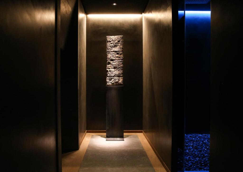 a hallway with a window and a column in a wall at Claris Hotel & Spa GL, a Small Luxury Hotel of the World in Barcelona