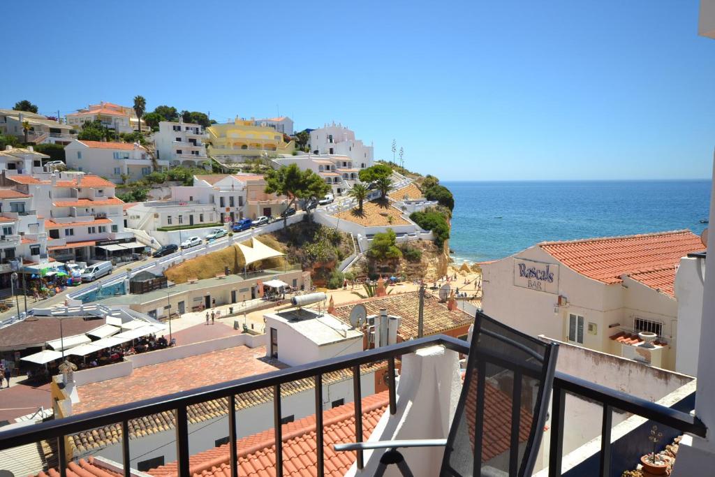 a view from a balcony of a town with the ocean at Apartments Miramare Miramonte in Carvoeiro