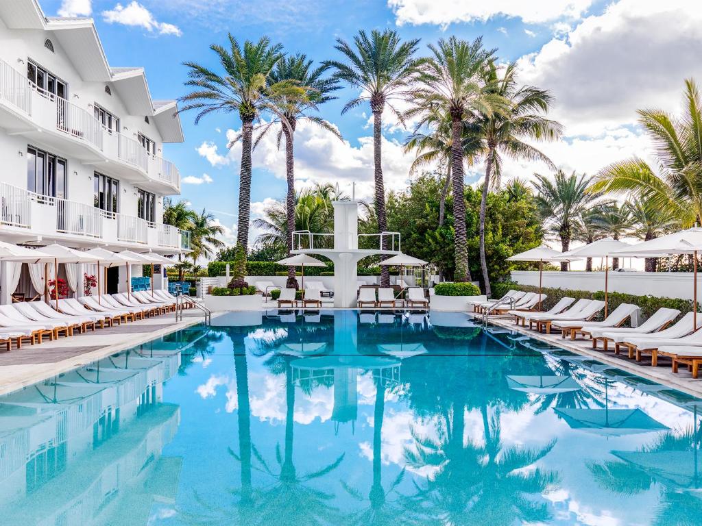 
a large swimming pool with a balcony overlooking a beach at Shelborne South Beach in Miami Beach
