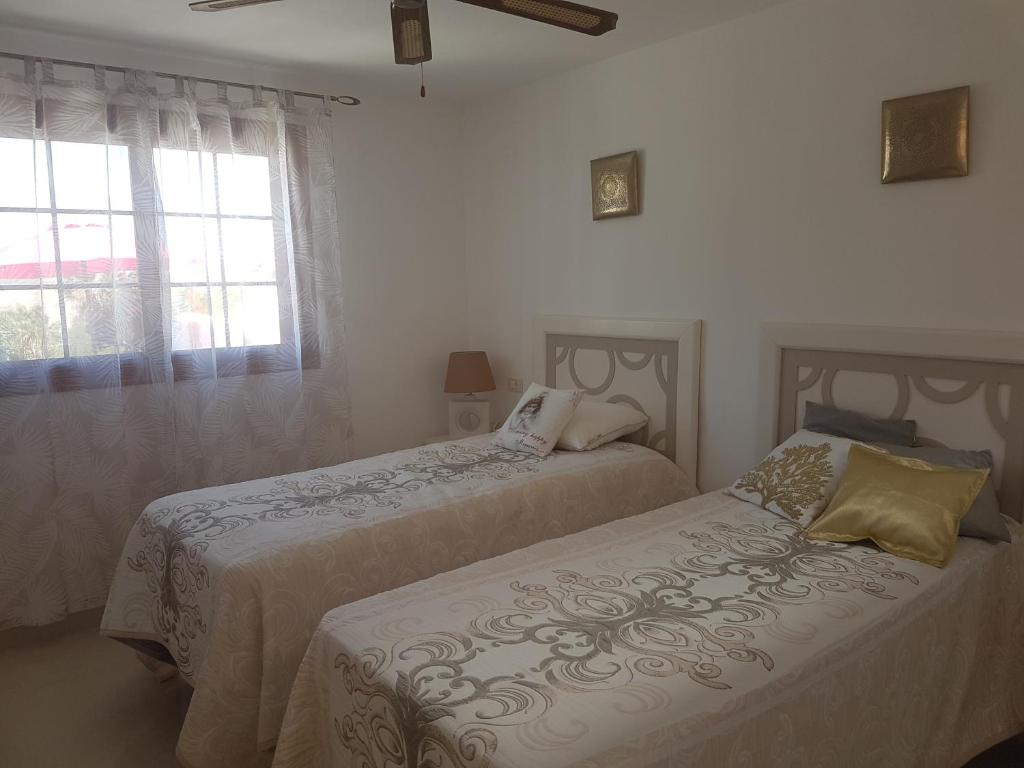 A bed or beds in a room at Villa Ola, Golf del Sur