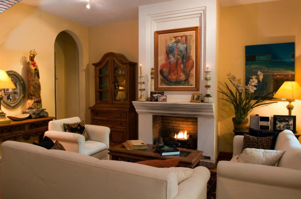 a living room with two couches and a fireplace at Casa Calderoni in San Miguel de Allende