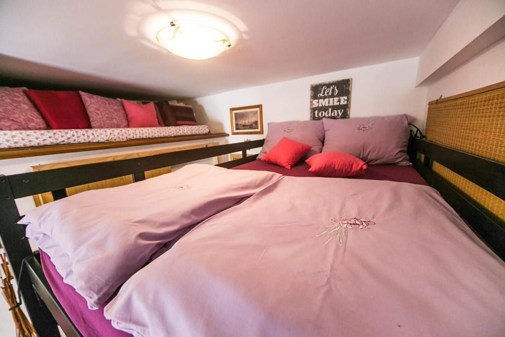 a bedroom with two bunk beds with red pillows at Apartments Baredi in Izola