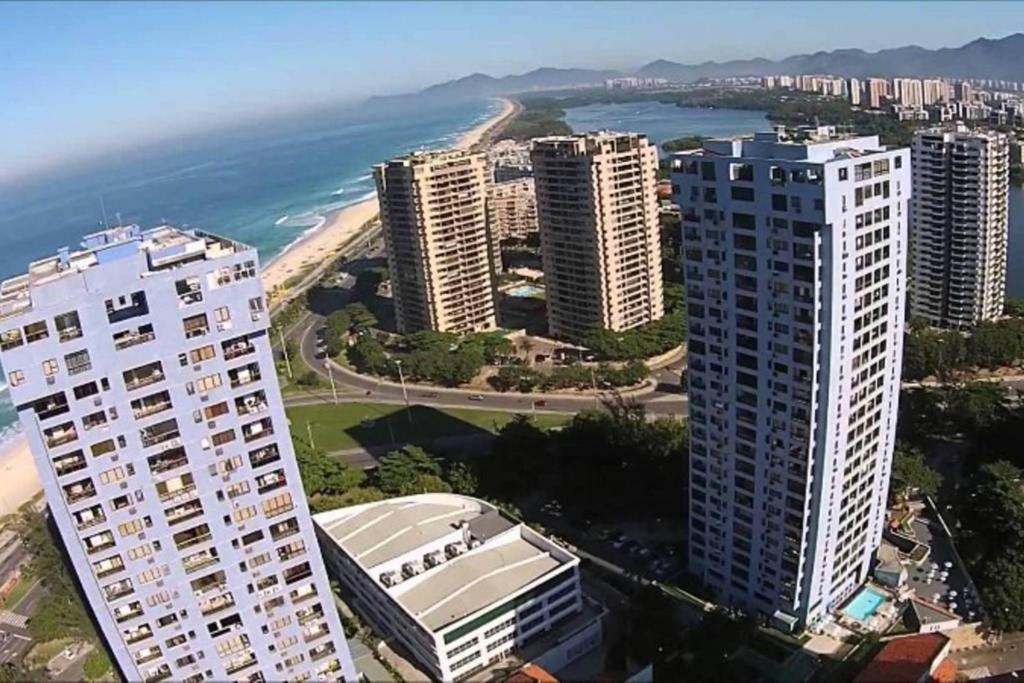 Hotel Apartamento Praia da Barra, a group of tall buildings next to the ocean at Apartamento Praia da Barra in Rio de Janeiro