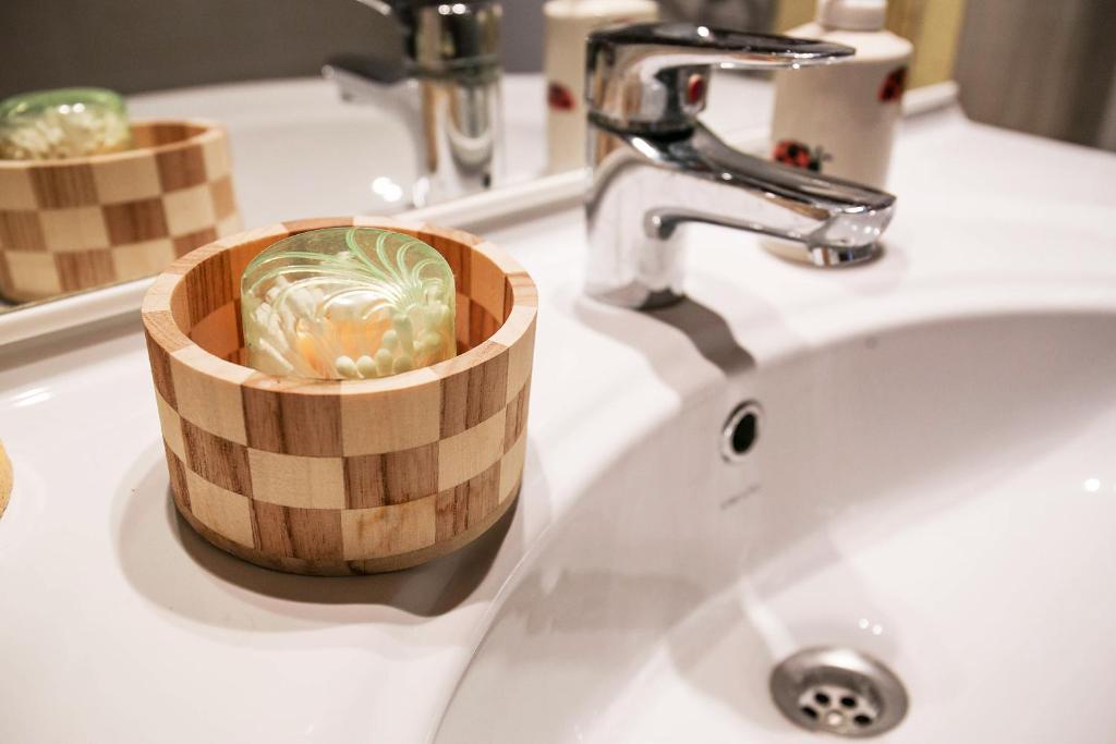 a bowl of vegetables sitting on a bathroom sink at Apartments Baredi in Izola