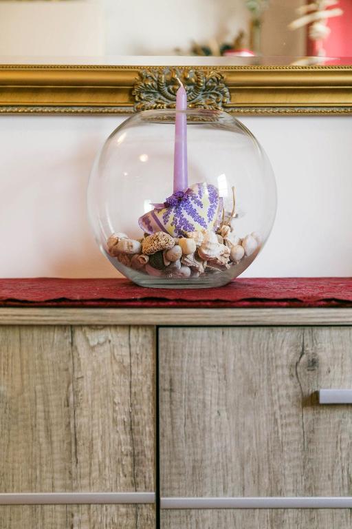 a glass bowl with a candle in it on a counter at Apartments Baredi in Izola