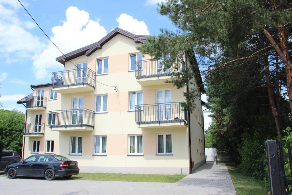 a building with a car parked in front of it at Fredry 8 in Piastów