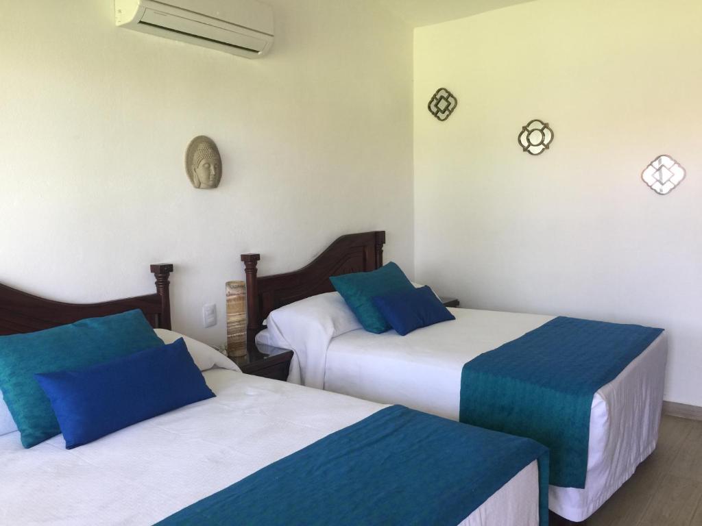 Postel nebo postele na pokoji v ubytování Ananta Hotel