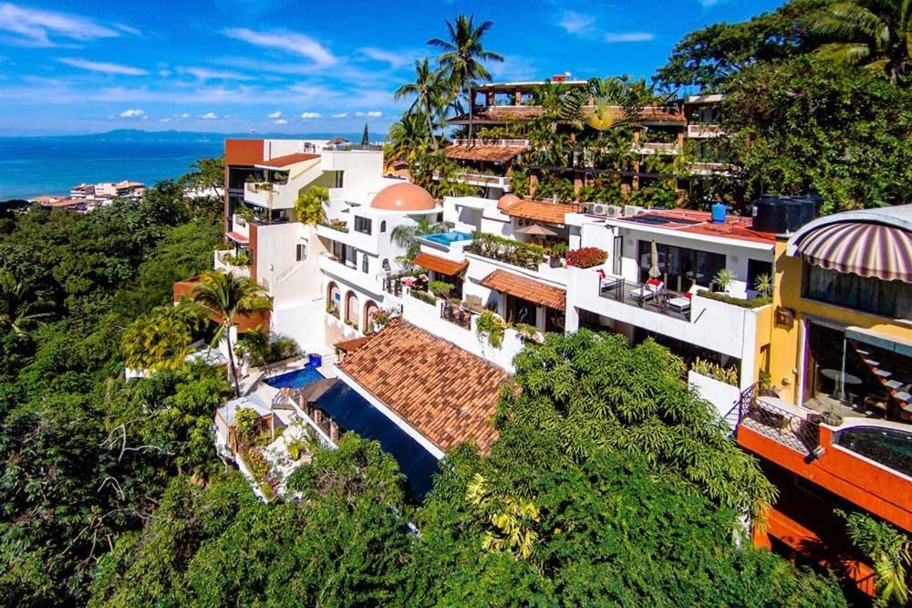 an aerial view of a building on a hill next to the ocean at Casa Cupula LGBT Luxury Resort in Puerto Vallarta