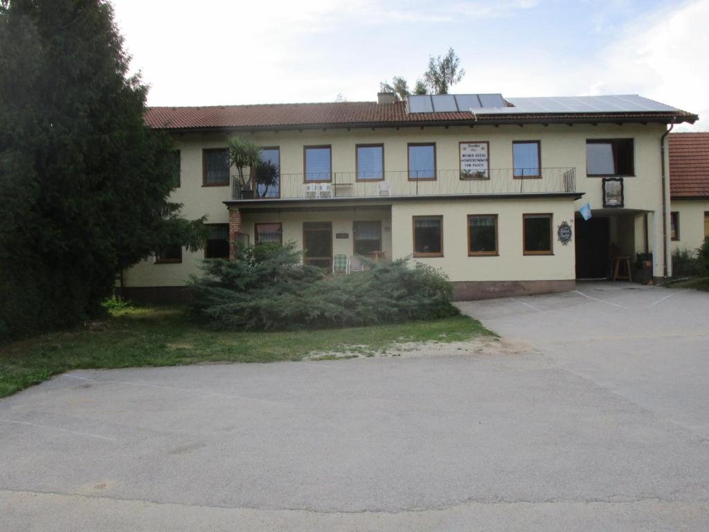 a large house with a parking lot in front of it at Dorfwirtshaus Rauch in Eschabruck