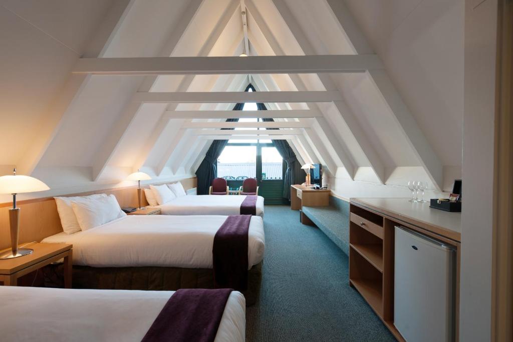 a hotel room with two beds and a window at Heartland Hotel Queenstown in Queenstown
