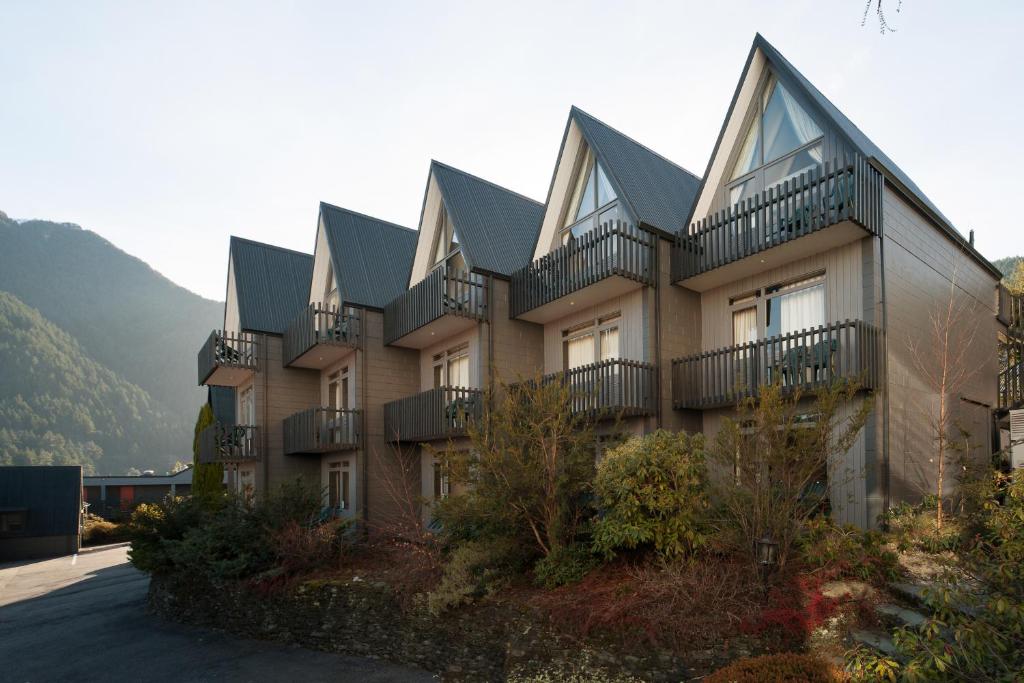 a building with balconies on the side of it at Heartland Hotel Queenstown in Queenstown