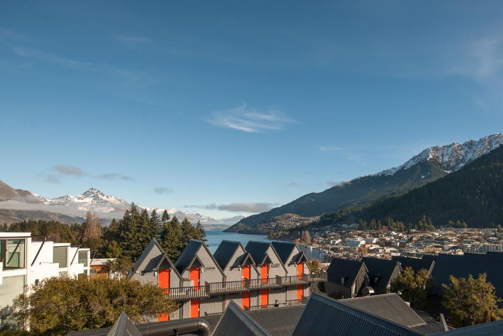 a view of a city with mountains and a lake at Heartland Hotel Queenstown in Queenstown