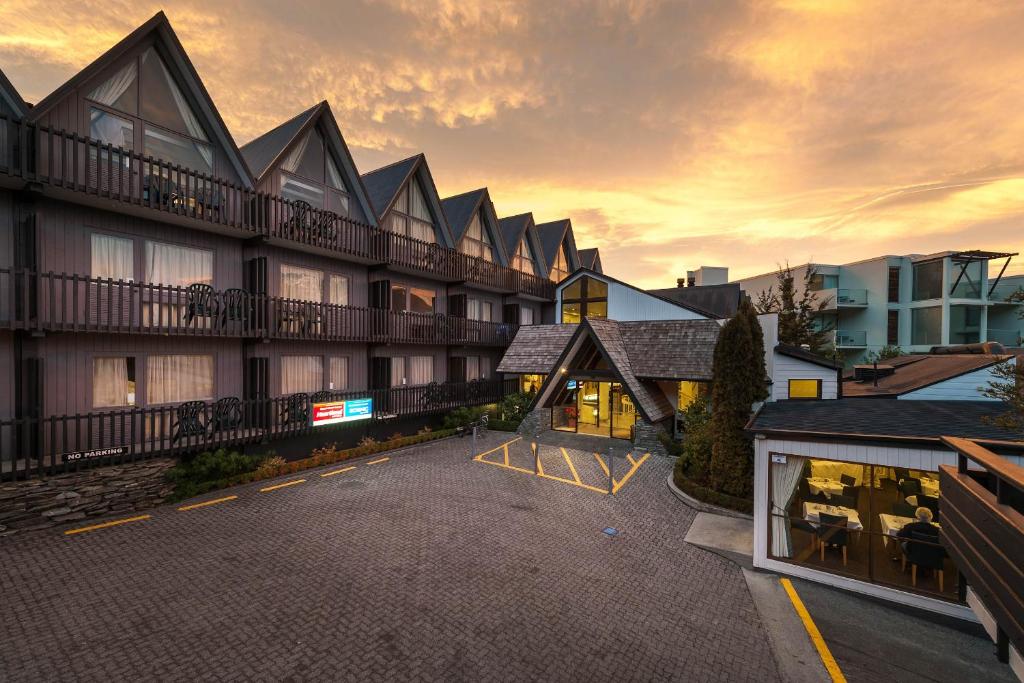 an empty parking lot in front of a building at Heartland Hotel Queenstown in Queenstown
