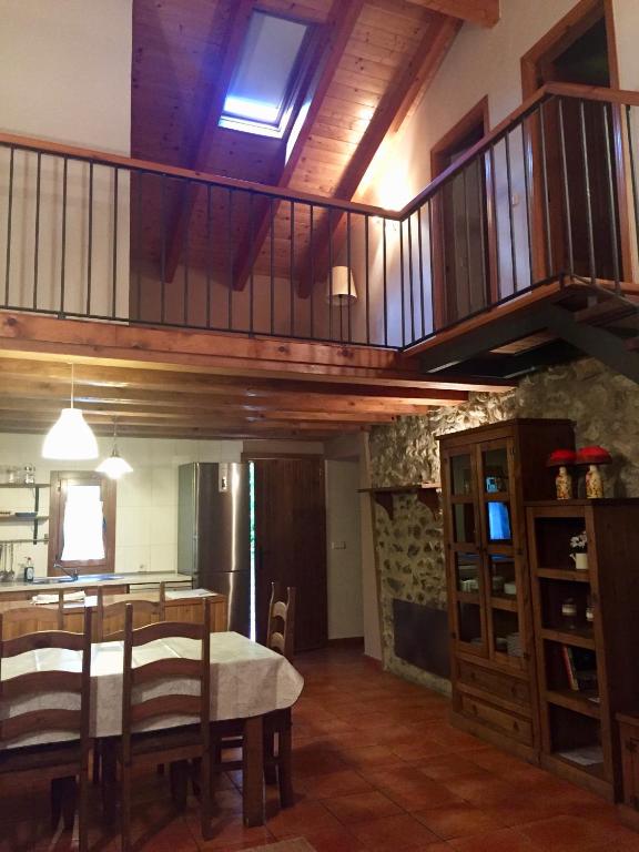 a kitchen and dining room with a table and a staircase at Casa Marcial in Chía