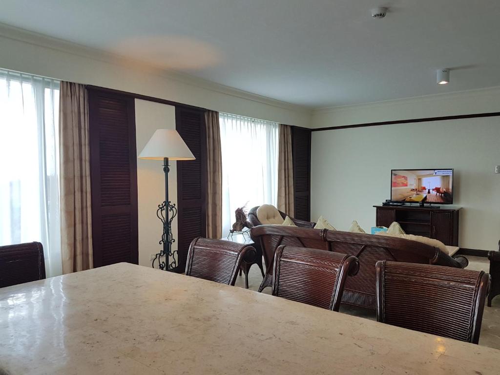 a living room with a large table and chairs at Waterfront Airport Hotel and Casino in Mactan