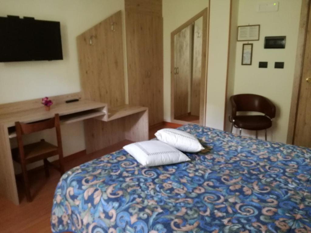Postel nebo postele na pokoji v ubytování Hotel Blanchetti