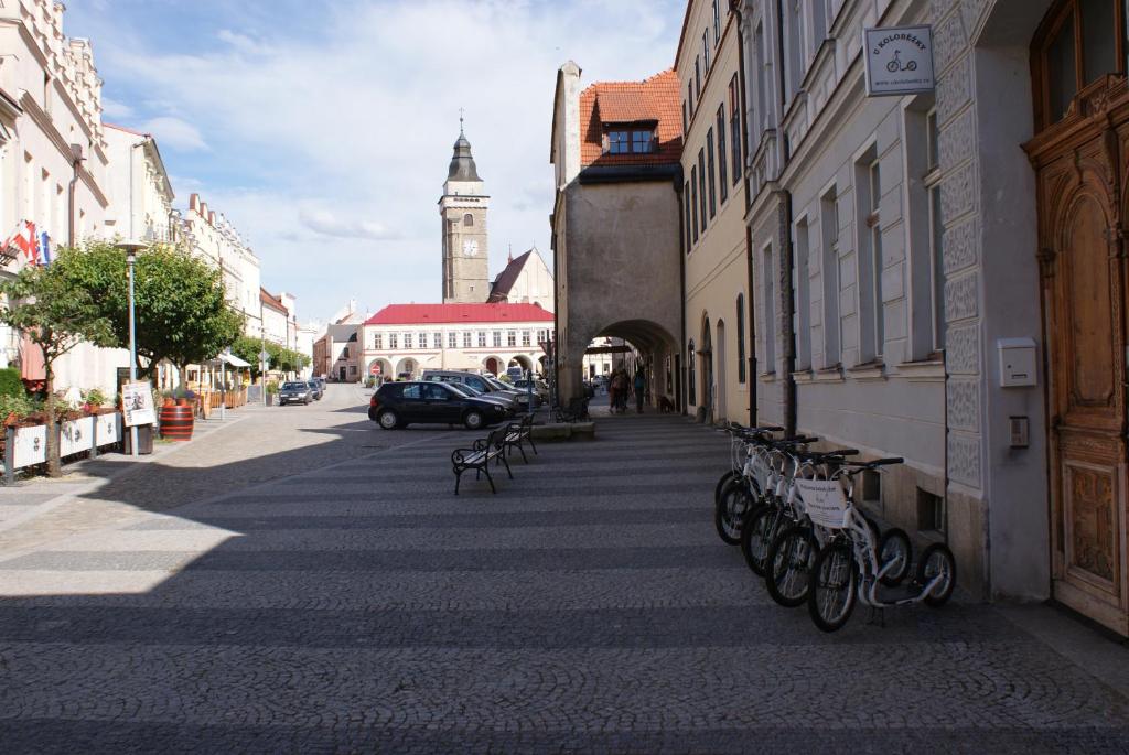 a city street with a clock tower in the distance at U koloběžky Apartment in Slavonice