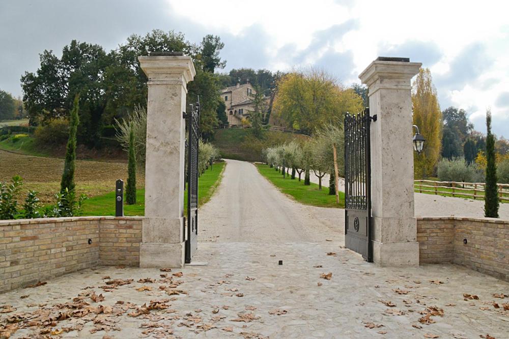 an entrance to a driveway with a stone gate at Villa Funari Country House in Servigliano