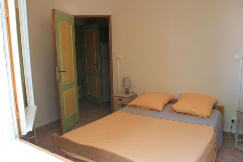 a small bedroom with two beds and a window at La Figalie in Saint Jean du Pin