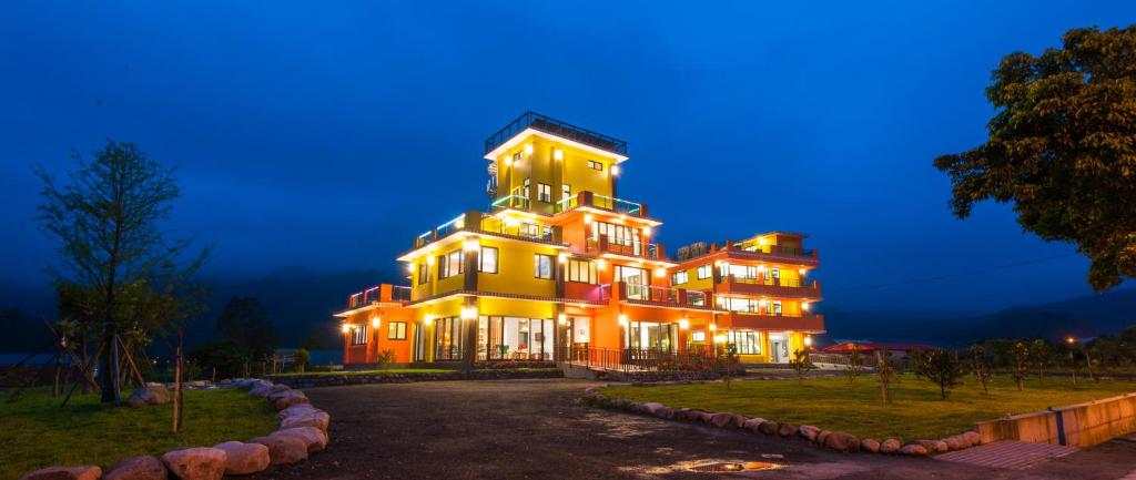 a large building is lit up at night at Geothermal Rise Leisure B&B in Tianfu