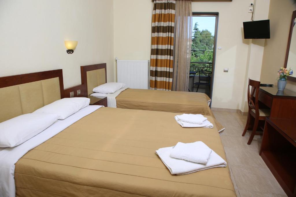 Postel nebo postele na pokoji v ubytování Hotel Zeus