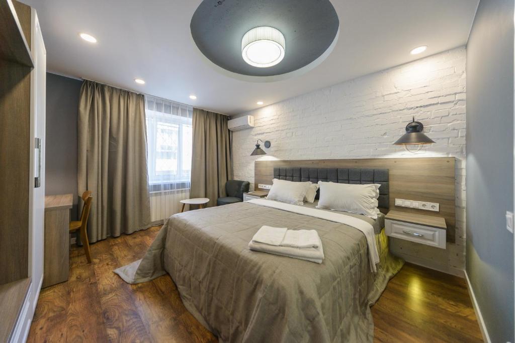 a bedroom with a large bed and a desk at Partner Guest House Saksahans'koho in Kyiv