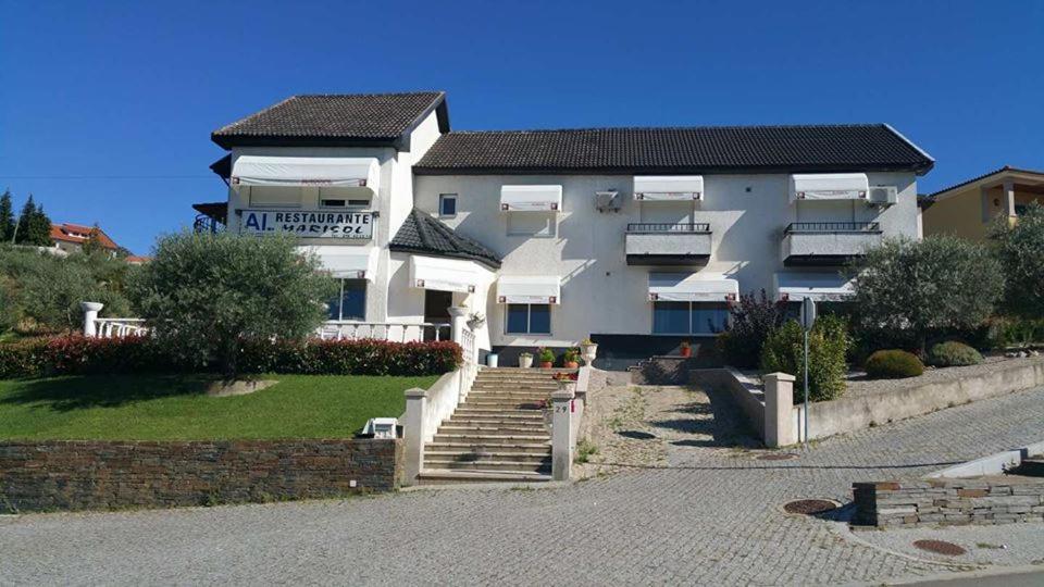 a large white building with stairs in front of it at Hotel Marisol in Macedo de Cavaleiros