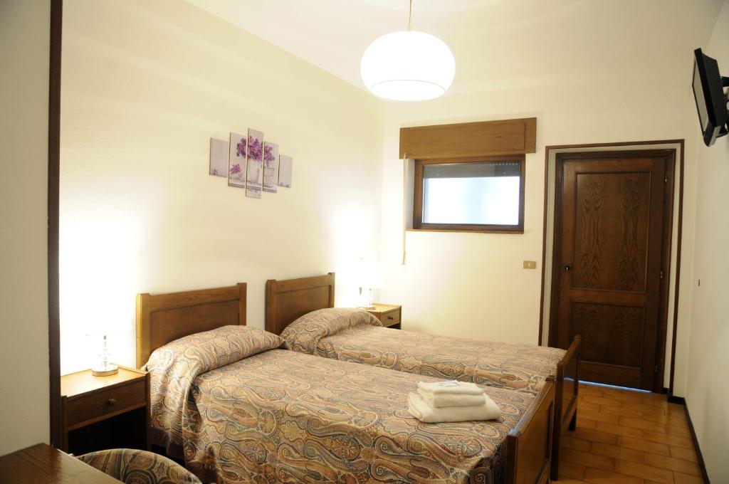 Postel nebo postele na pokoji v ubytování Hotel Eternità
