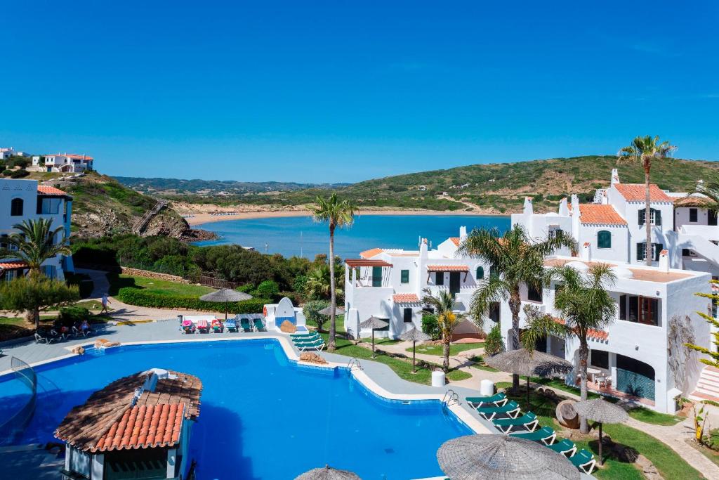 an aerial view of a resort with a swimming pool at Carema Garden Village in Fornells