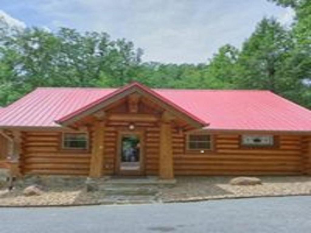 a log cabin with a red roof at Bearly Lovers in Gatlinburg