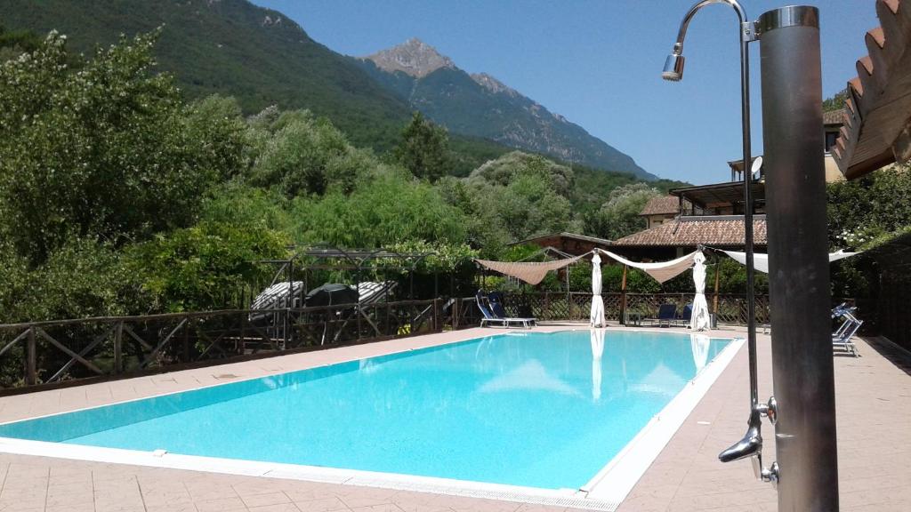 a swimming pool with a mountain in the background at Locanda del Ponte B&B in Balsorano Vecchio