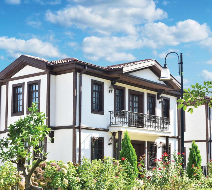 a white house with black windows at Zagnospasa Konaklari in Trabzon