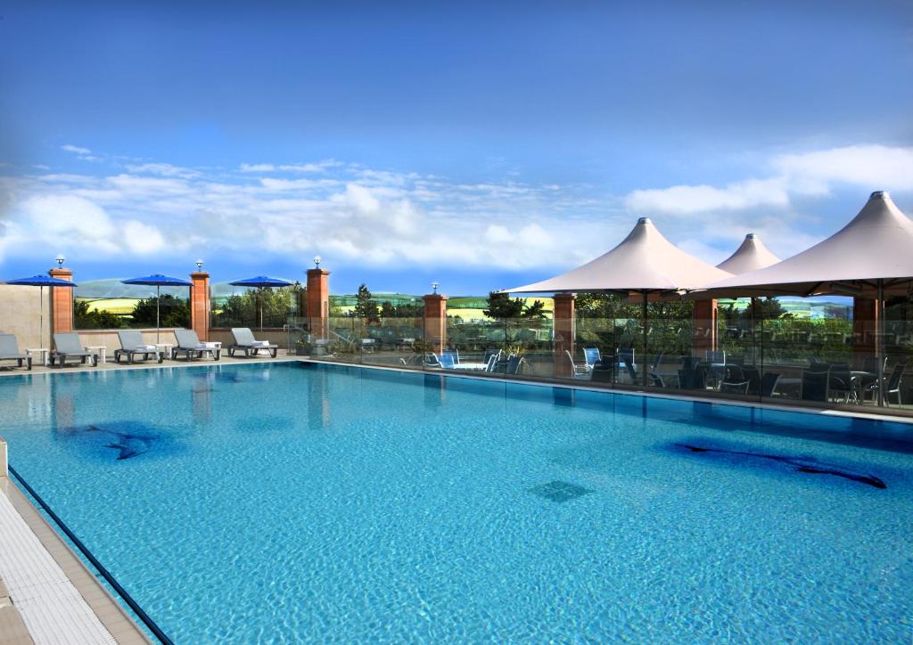a large swimming pool on top of a building at Thurlestone Hotel in Thurlestone