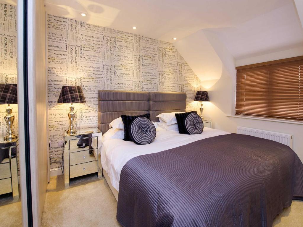 a bedroom with a bed and a wall covered in papers at Five Star Stays in Scarborough