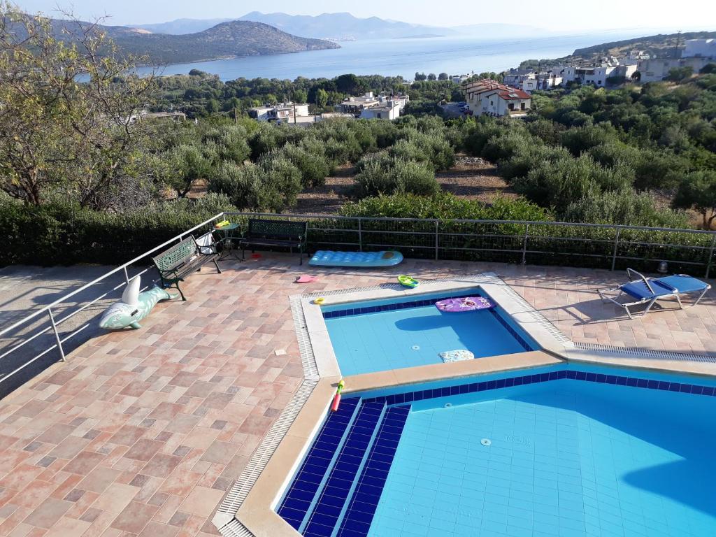 a swimming pool with a view of the water at Stelios Apartments in Istro