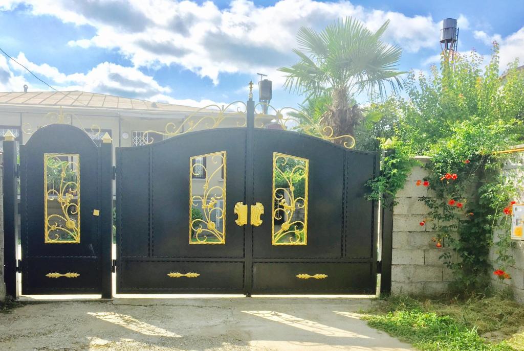 a black gate with gold designs on it at Guest House Lali Kostava 14 in Zugdidi