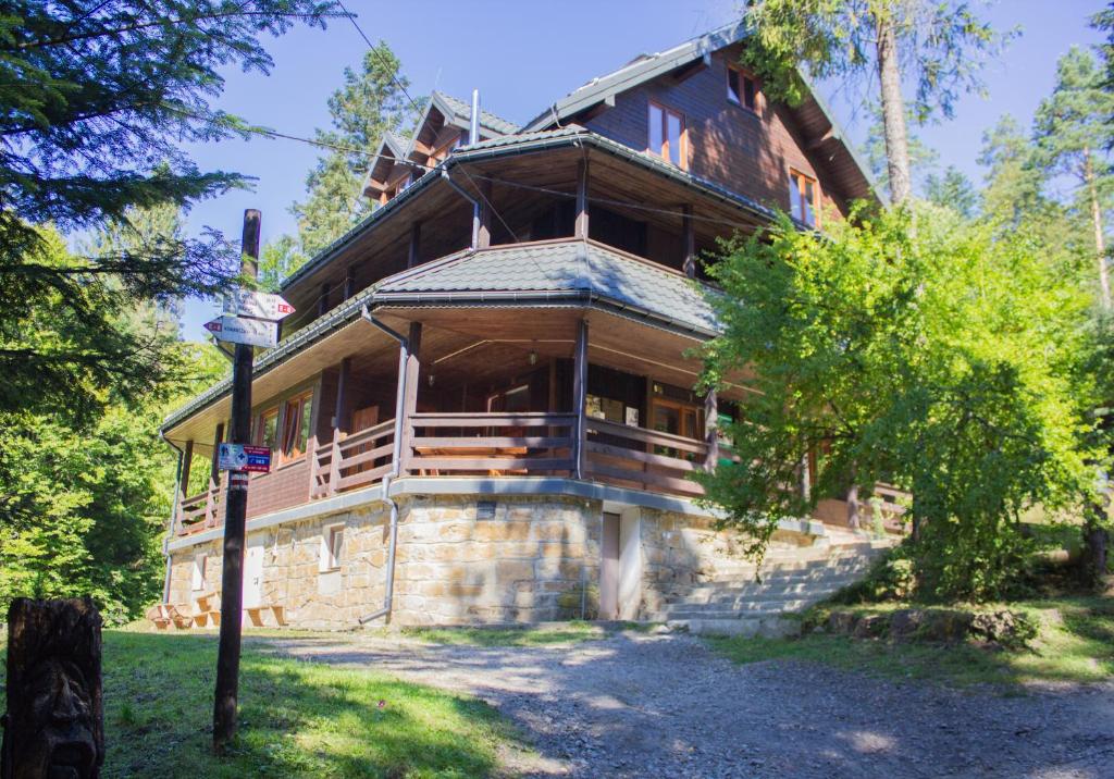 una gran casa de madera en medio de árboles en Leśna Willa PTTK w Komańczy, en Komańcza