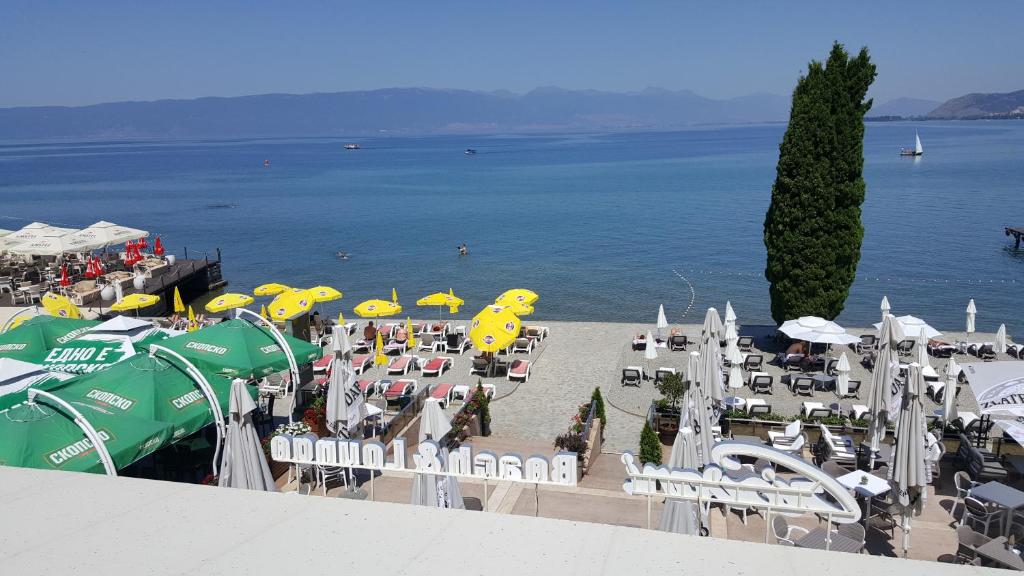 a view of a beach with chairs and umbrellas at Park Beach Apartment in Ohrid