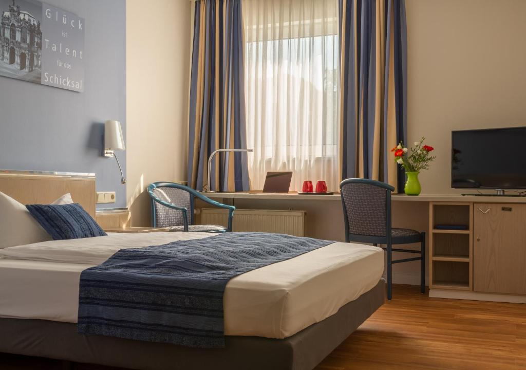 Postel nebo postele na pokoji v ubytování NOVALIS Hotel by AURUM Dresden