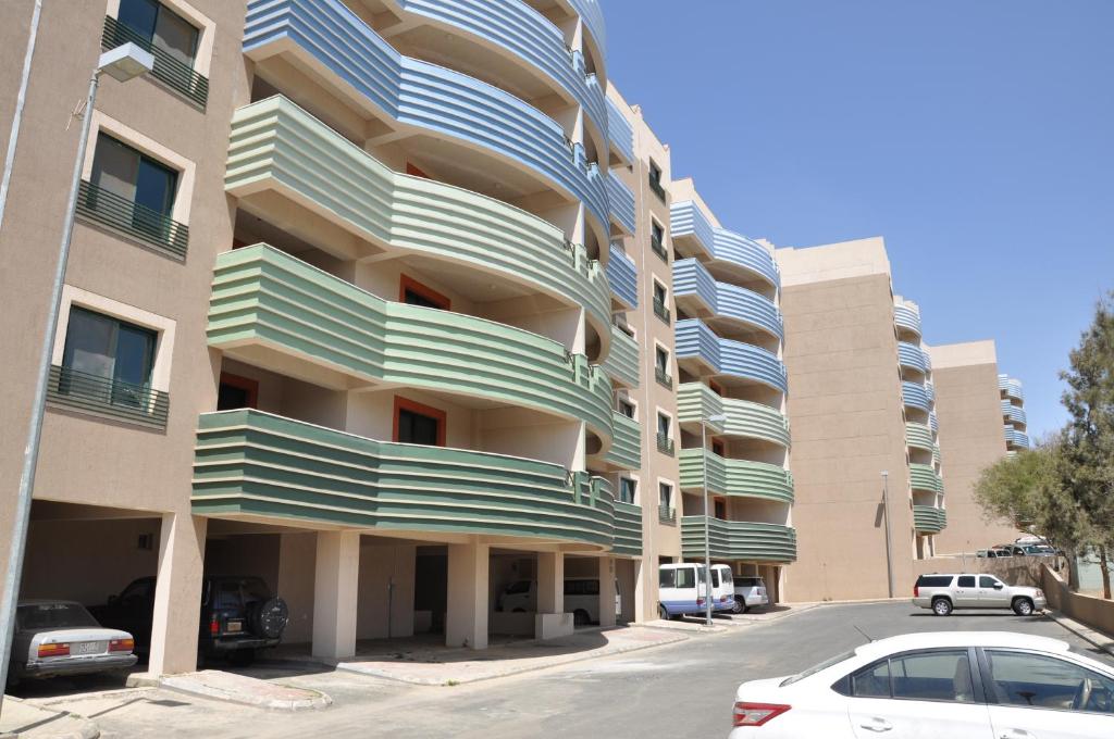 a large apartment building with a car parked in front of it at New Abha Resort in Abha