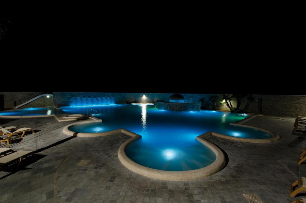 a swimming pool with blue water at night at Complesso Termale Vescine in Castelforte