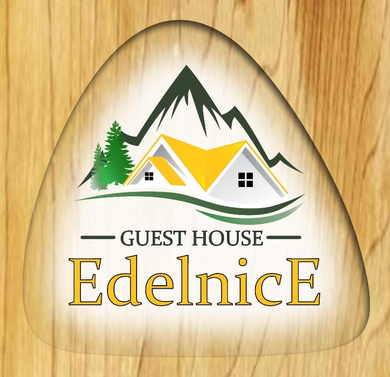 a crest of a guest house estate with a tent and trees at Guesthouse Edelnice in Gornja Trepča