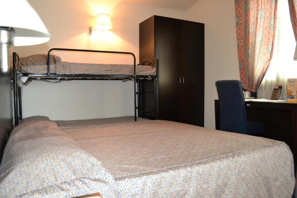 Postel nebo postele na pokoji v ubytování Hotel I' Fiorino