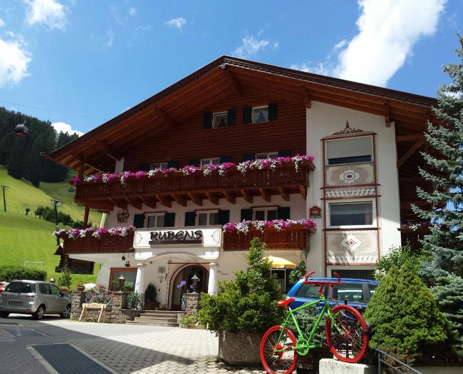 a building with flowers on the front of it at Garni Rubens B&B in Selva di Val Gardena