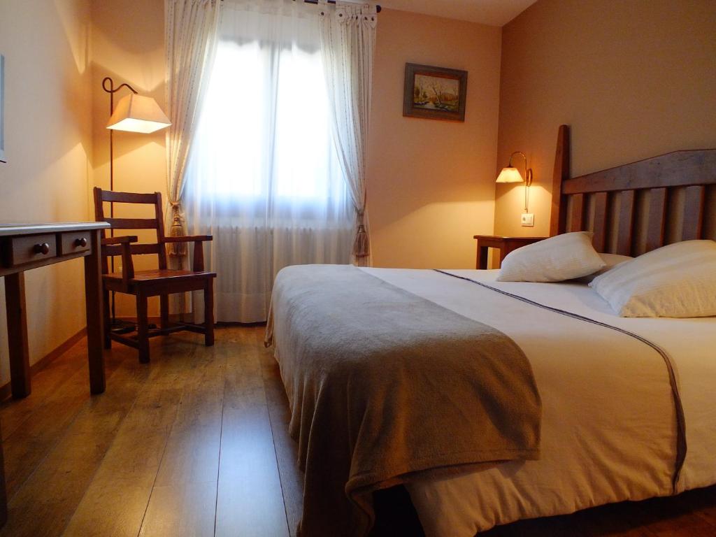 Postel nebo postele na pokoji v ubytování Hotel Areulo