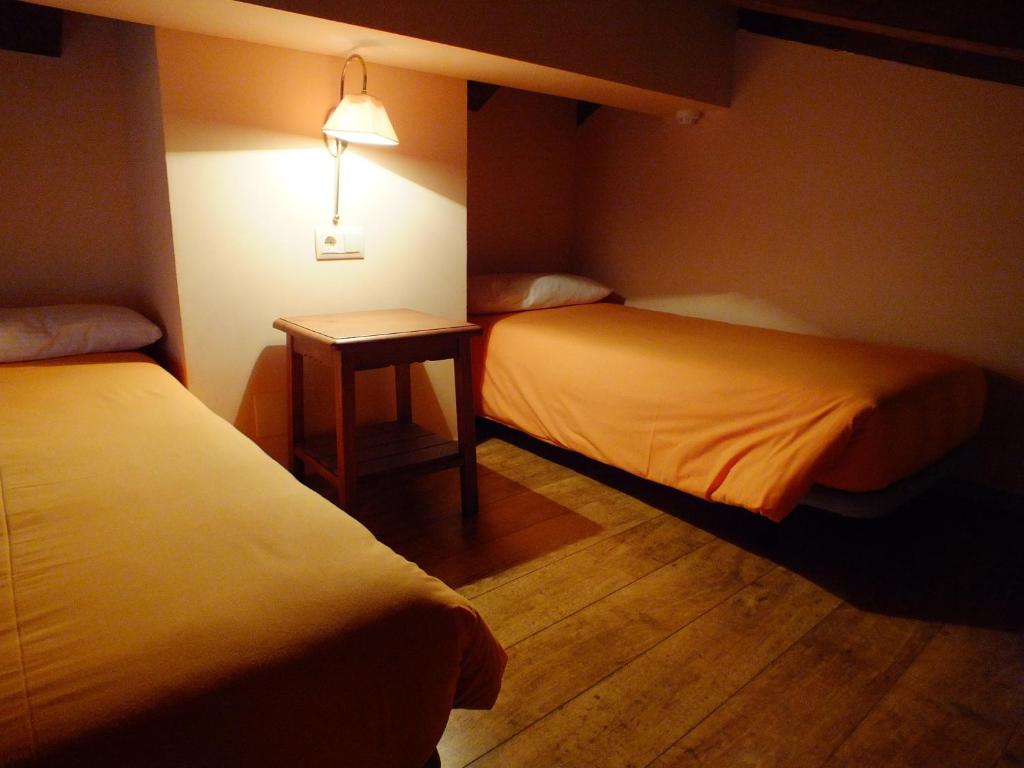 Postel nebo postele na pokoji v ubytování Hotel Areulo