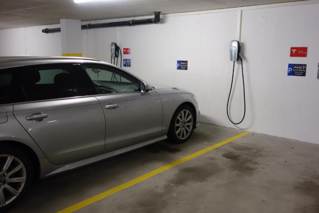 a car is being charged in a parking garage at Hotel AVA in Sempach Station
