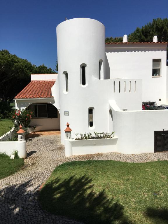 a white building with a tower in the yard at Vale Do Lobo 935 in Loulé