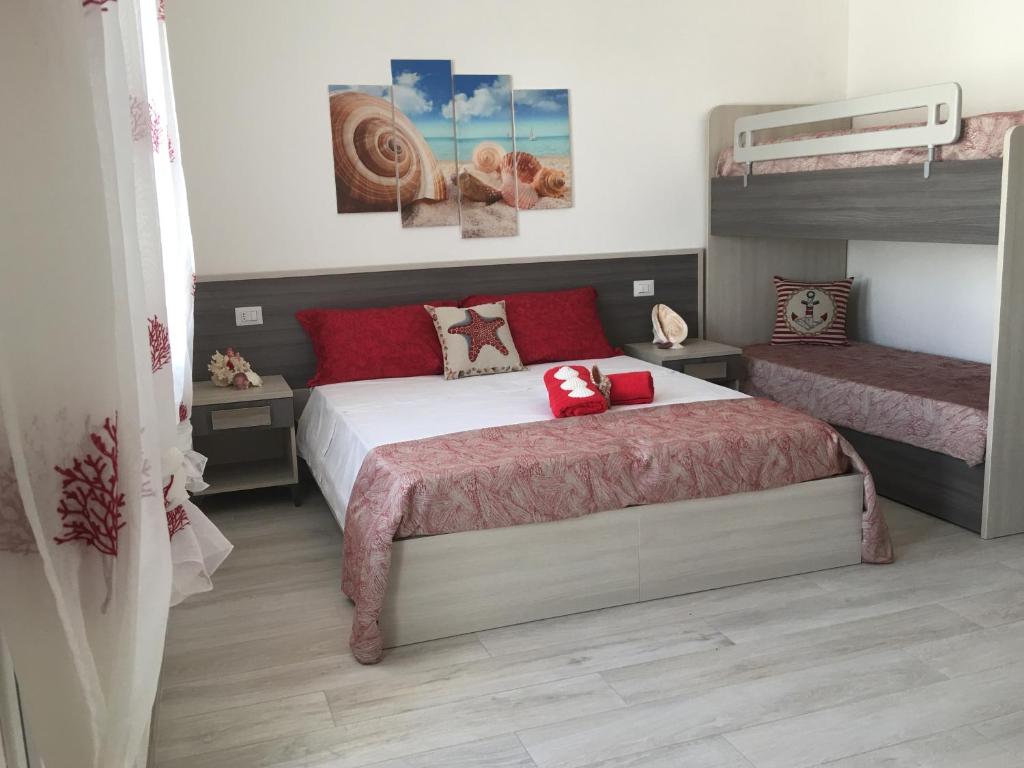 a bedroom with a bed and two bunk beds at Albachiara in Sant'Isidoro